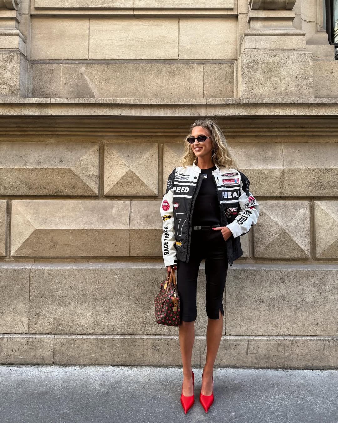 @emilisindlev wears black capri pants, Louis Vuitton bag and motorbike jacket