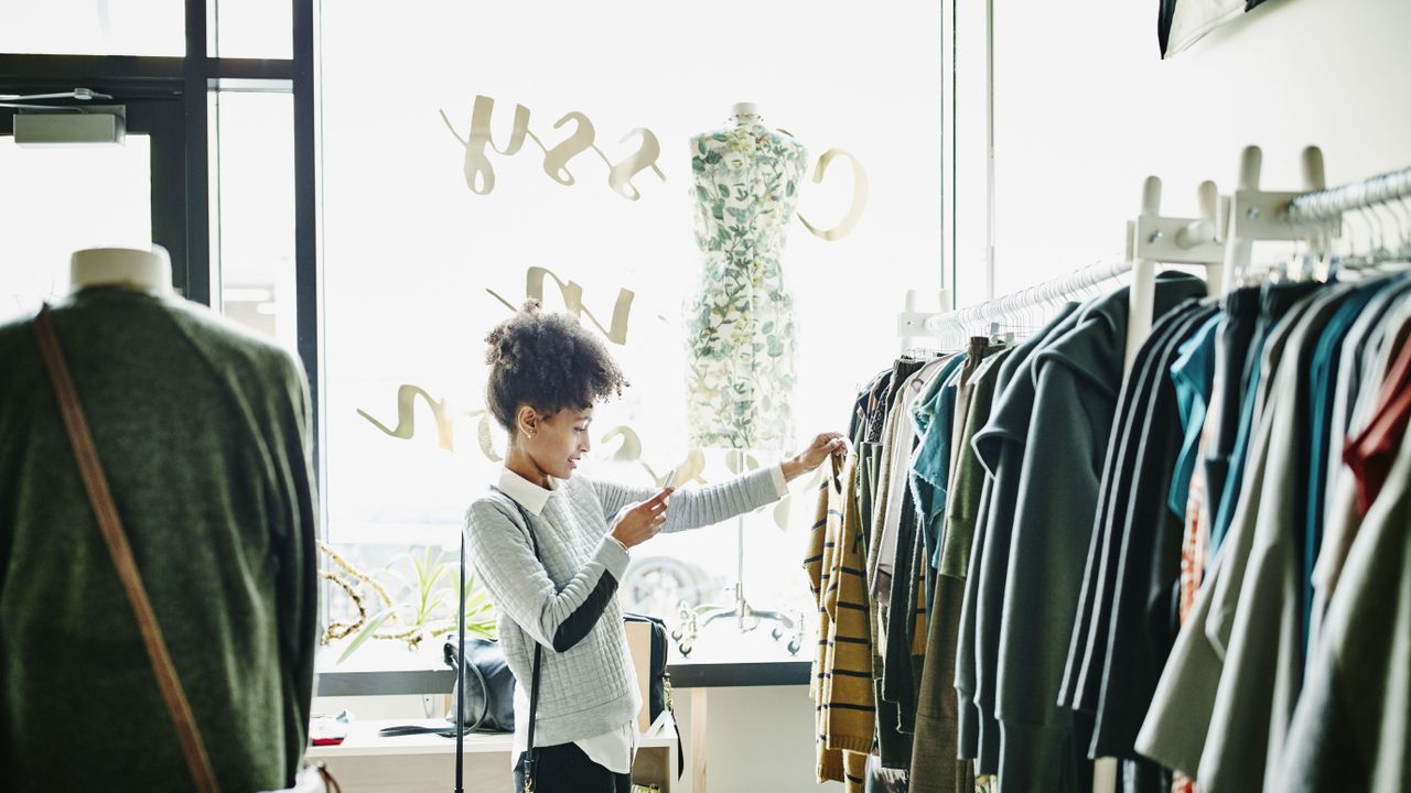 Woman taking photo of clothing with smartphone