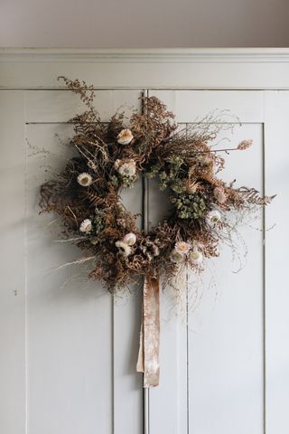 Dried flower wreath by Honeysuckle & Hilda with a naturally dyed ribbon