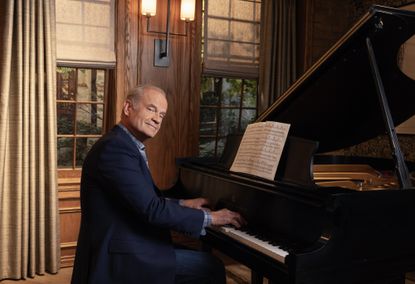 Kelsey Grammer sitting at a grand piano as Frasier Crane in the reboot of the TV show 'Frasier'