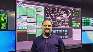 Tony Petro stands in front of a massive LED display from MAXHUB in the Westgate Resorts control center. 