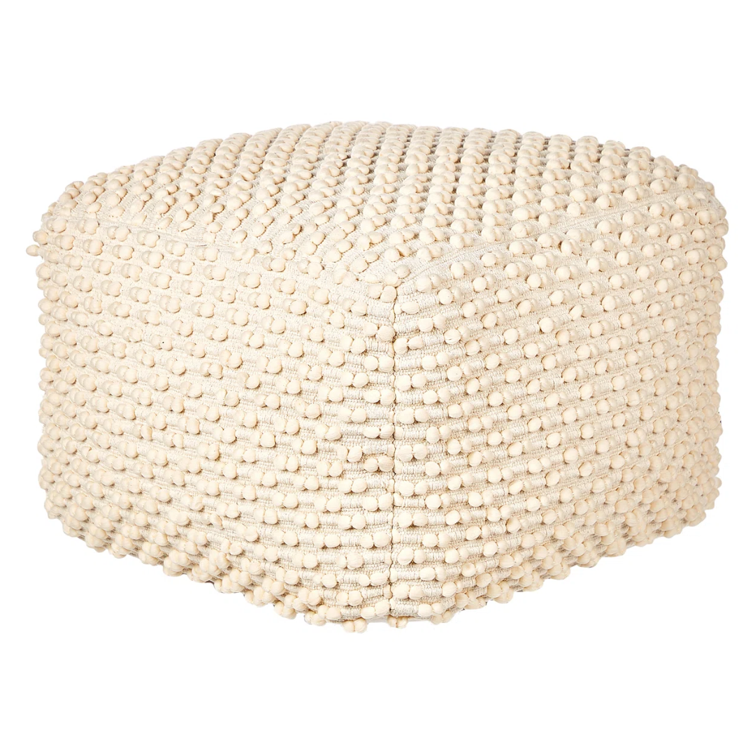 white fabric pouffe with white knobs