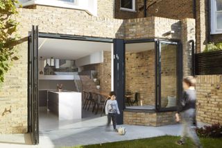 Kitchen extension with exposed brick wall by Scenario Architecture