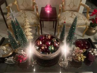 a dazzling christmas centerpiece with a collection of ornaments and bottle brush trees