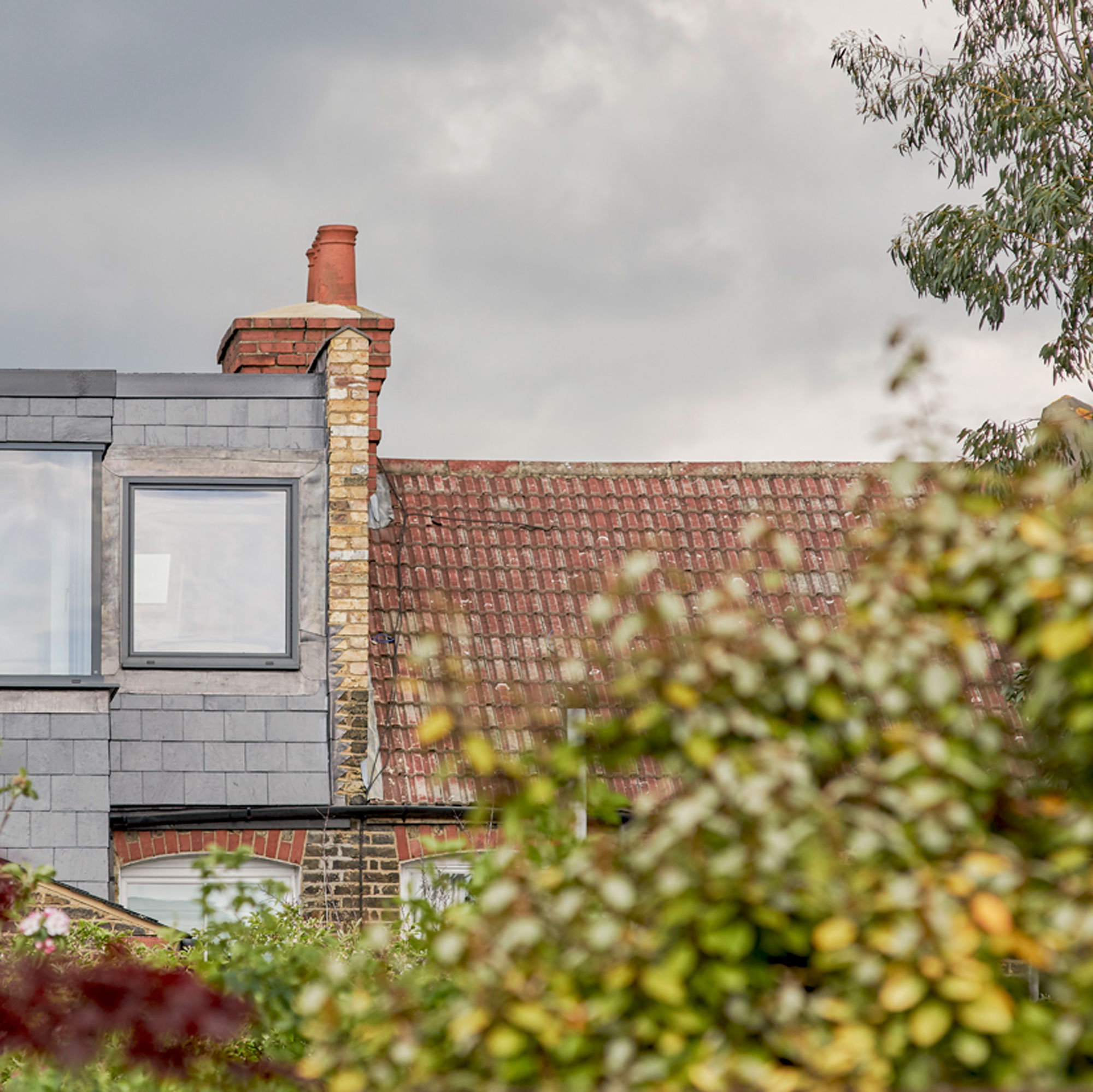 clay tiled roof next to slate domer loft conversion