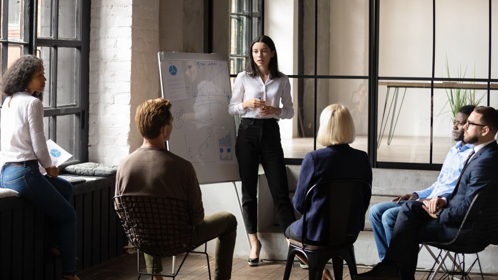 An office executive training employees in an office space