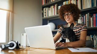 Woman at computer with dog