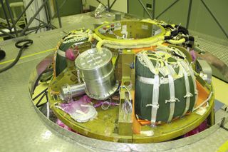 Various pieces of equipment are seen including rolled-up parachutes.