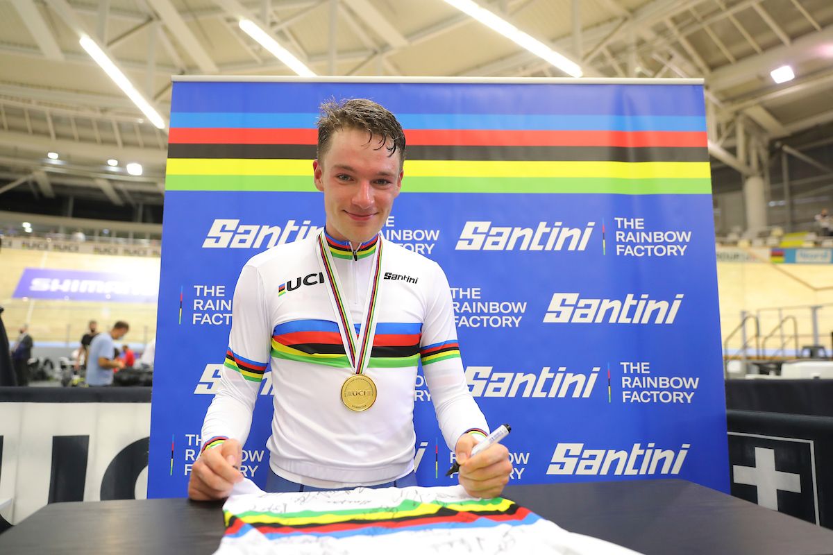 Picture by Alex Whitehead/SWpix.com - 23/10/2021 - Cycling - Tissot 2021 UCI Track Cycling World Championships - Men's Omnium - Stab Velodrome, Roubaix, France - Great Britain's Ethan Hayter signing Santini rainbow jerseys after taking gold in the men's omnium points race final.