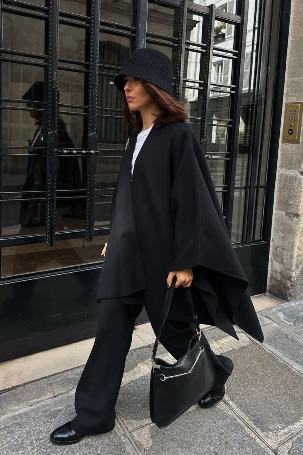 @deborabrosa Petite Fashion Trends Winter 2025 wearing a black cape and trousers