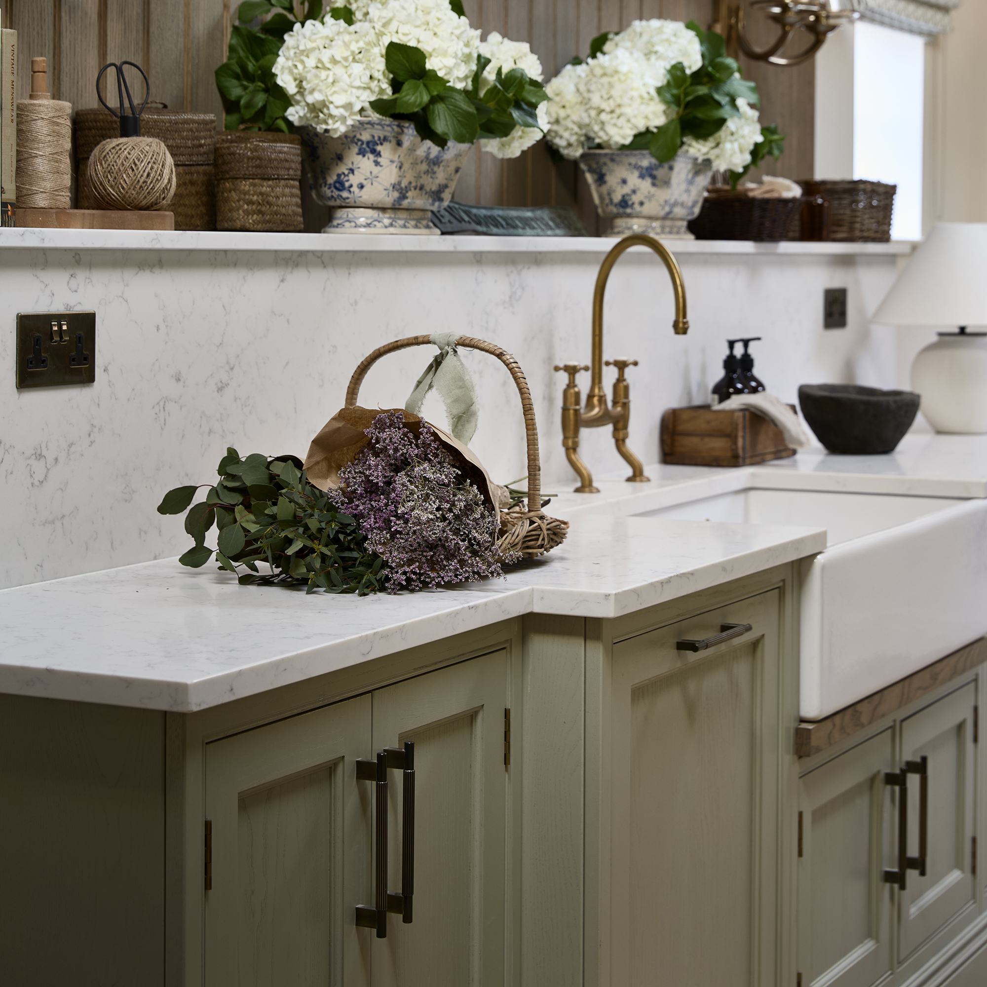 Brass hardware on a green shaker kitchen