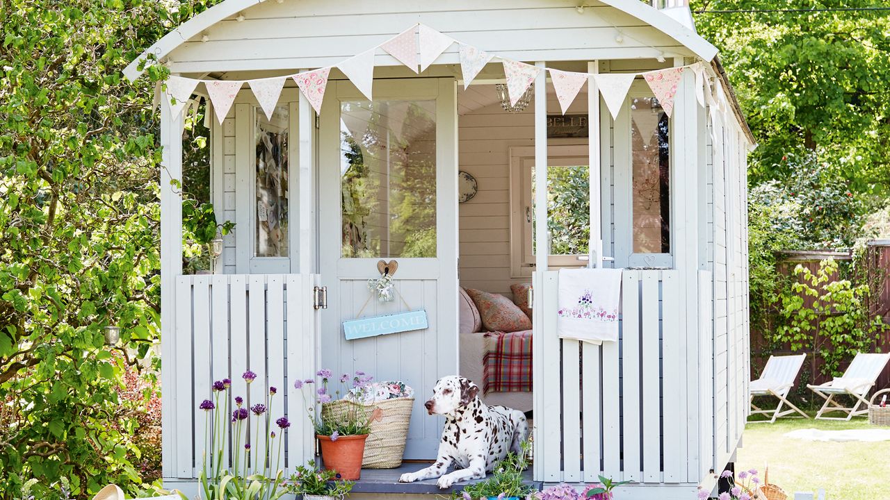 shepherd&#039;s hut in summer with dog in doorway