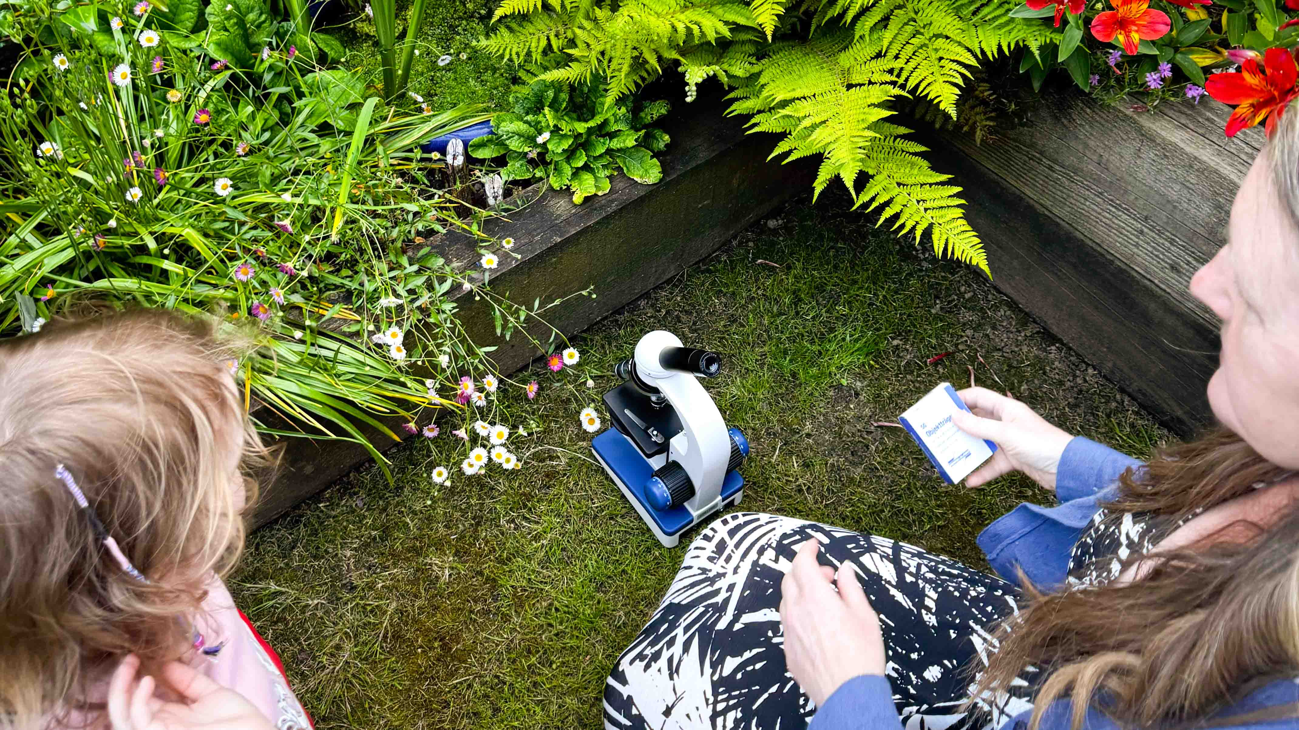 Microscope on grass in front of a pond