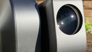 Close up of the lens on a ZWO Seestar S50 telescope outside