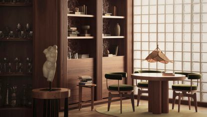 Study/dining room with dark wood shelves, lighter wood floor and round wooden table and chair in green velvet