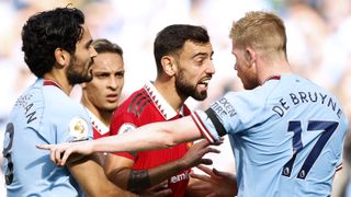 Bruno Fernandes of Manchester United clashes with Ilkay Gundogan and Kevin De Bruyne of Manchester City during the Premier League match between Manchester City and Manchester United