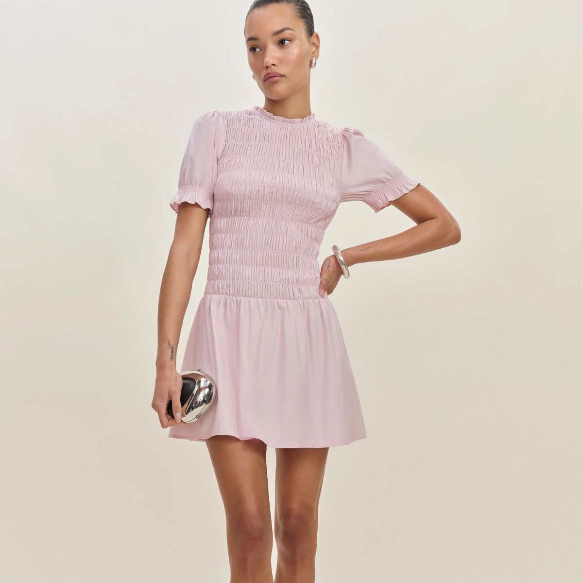 model wearing pink Reformation dress