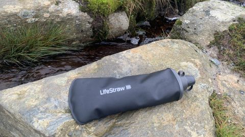 Lifestraw Peak Series Collapsible Squeeze 1L Water Bottle with Filter on a rock