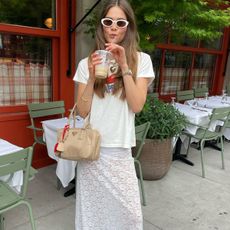 Woman in graphic tee and lace skirt