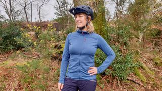 A female tester wearing the Rab Ascendor Light Hoody