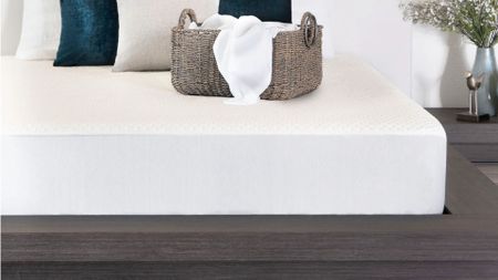 The Brooklyn Bedding Luxury Cooling Mattress Protector on a mattress in a white bedroom 