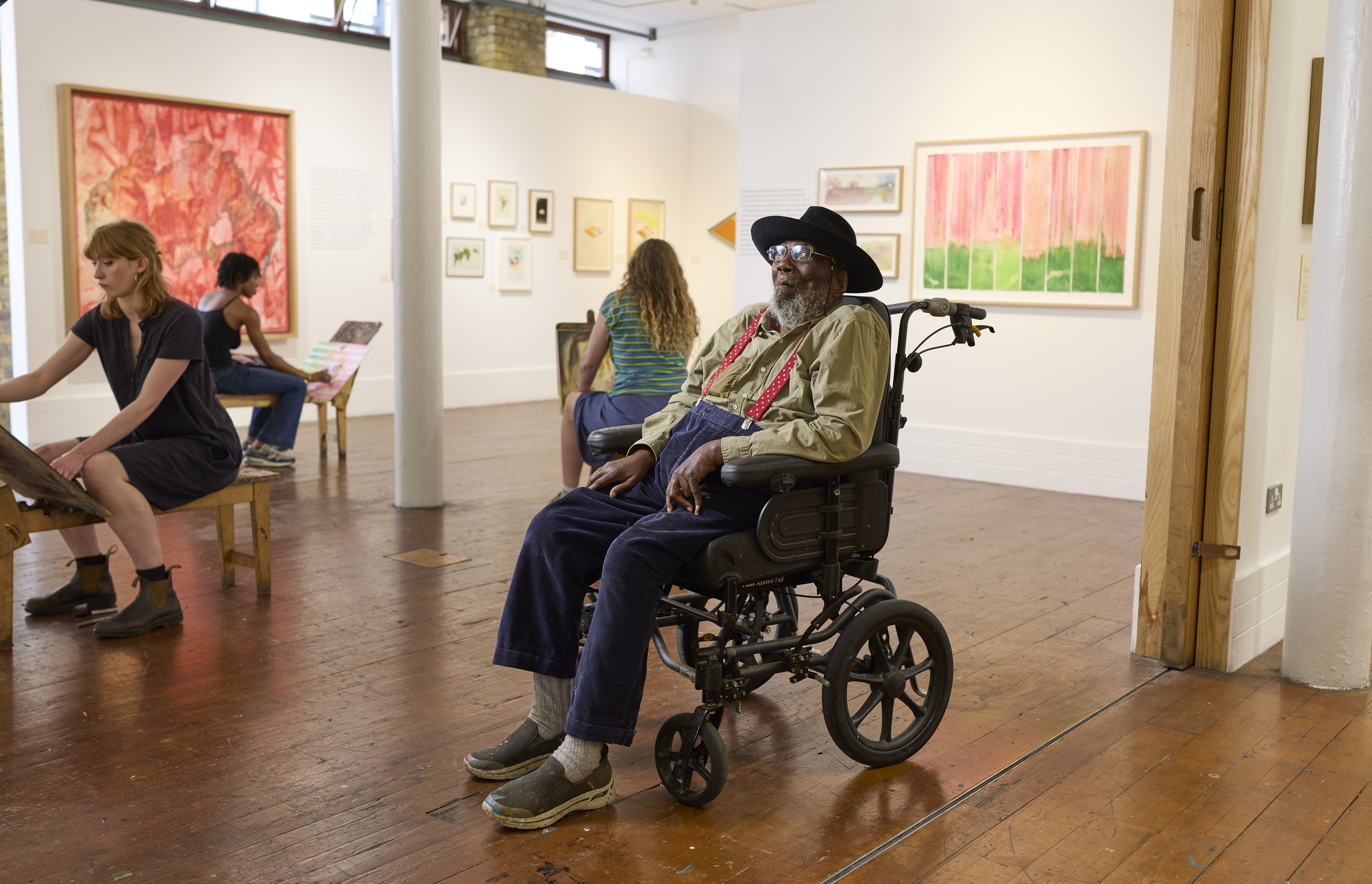 Frank bowling in front of his artwork at the royal drawing school