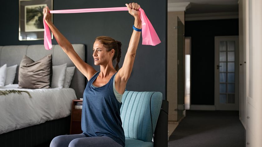 a photo of a woman holding a resistance band in a chair