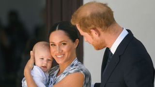The Duke and Duchess of Sussex smile with son Archie during a meeting with Archbishop Desmond Tutu