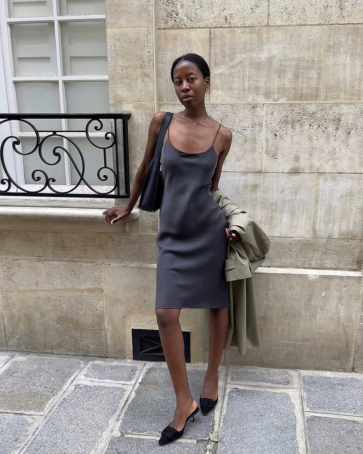 @sylviemus_ wearing a grey mini dress