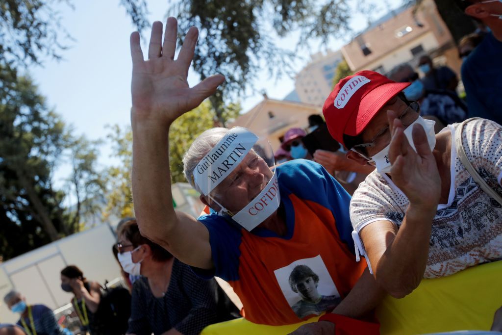 A supporter of Team Cofidis rider Frances Guillaume Martin waits for the riders prior to the 7th stage of the 107th edition of the Tour de France cycling race 168 km between Millau and Lavaur on September 4 2020 Photo by Christophe Ena POOL AFP Photo by CHRISTOPHE ENAPOOLAFP via Getty Images