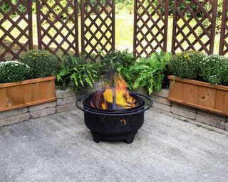 Aldi fire pit on a small patio with trellises
