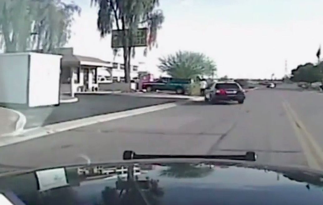 Dash-cam video shows a police car ramming into a robbery suspect