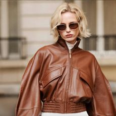 Woman wearing leather jacket and sunglasses from 24S