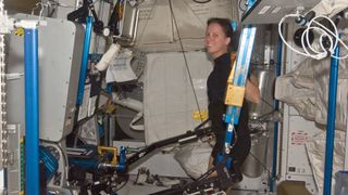 NASA astronaut Shannon Walker, Expedition 24 flight engineer, exercises using the advanced Resistive Exercise Device (aRED) in the Tranquility node of the International Space Station, on July 11, 2010.