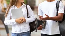 Samsung Galaxy Chromebook Go review: woman holding chromebook talking to a man