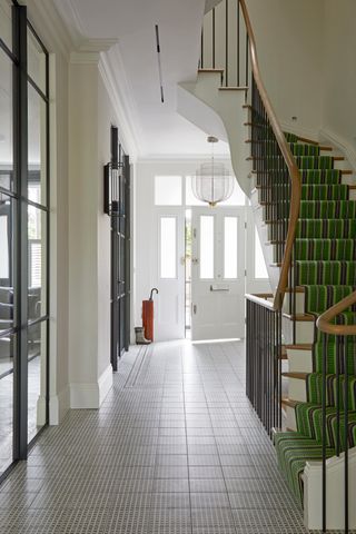 Large hallway with striped green runner