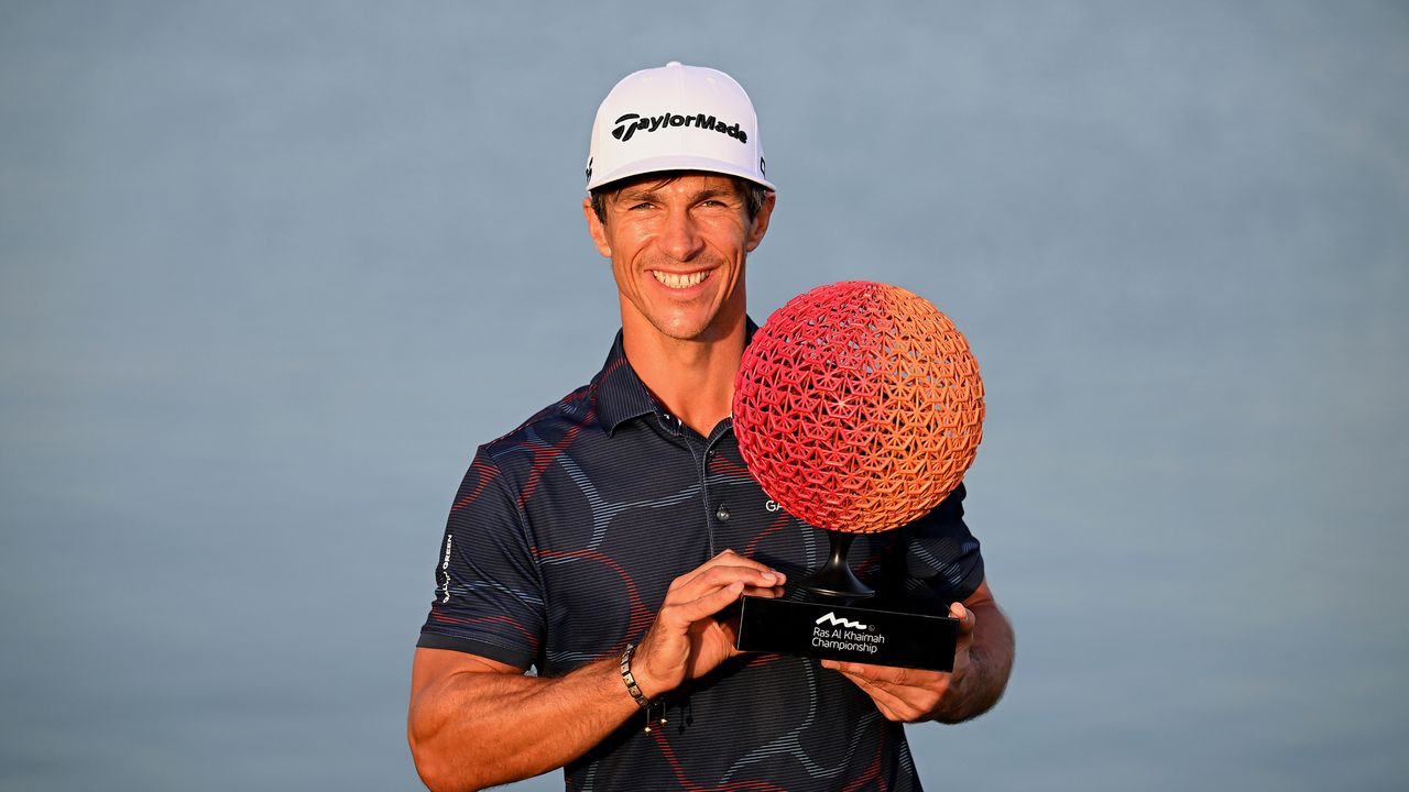 Thorbjorn Olesen holds the 2024 Ras Al Khaimah Championship trophy