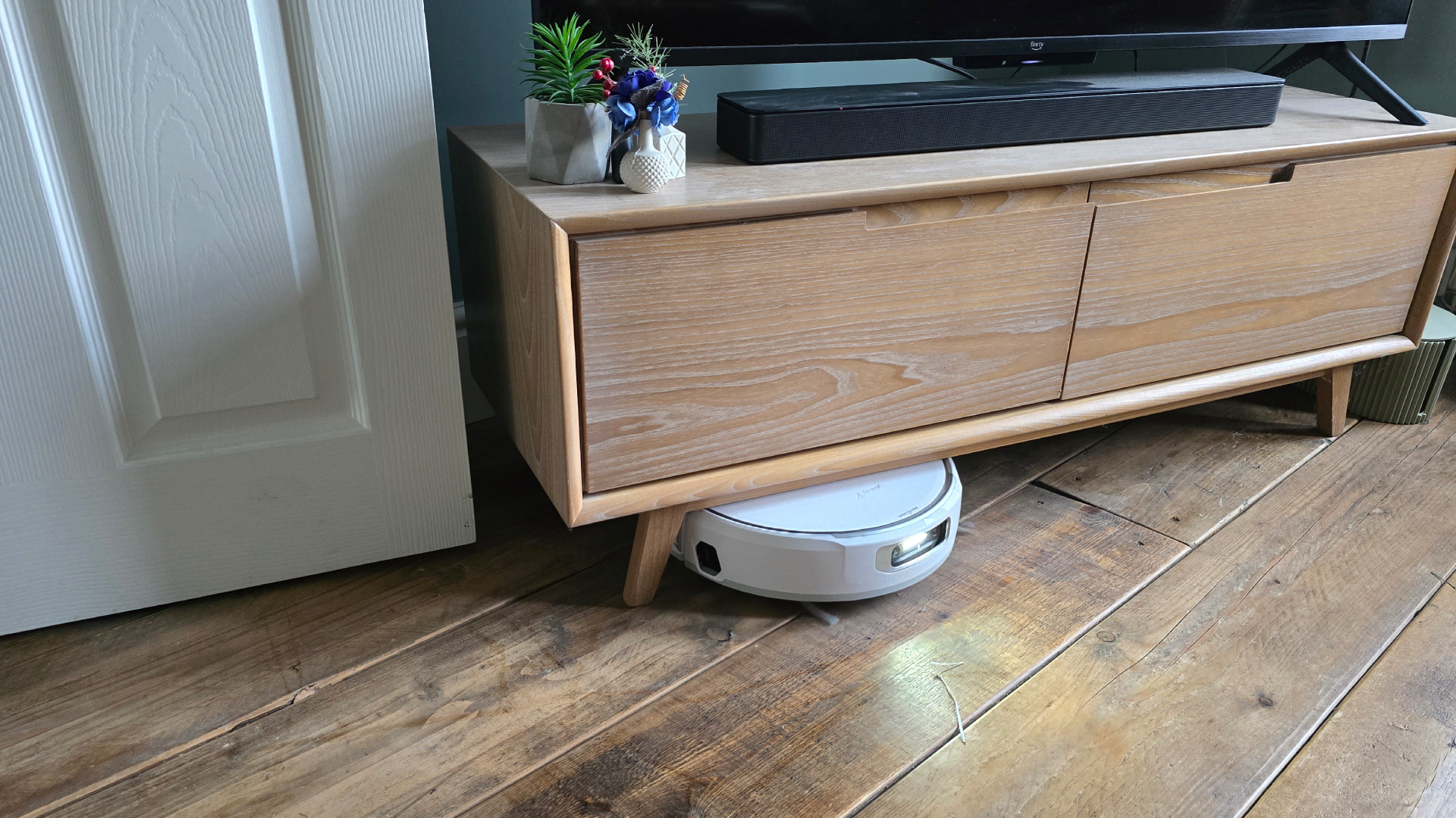 Narwal Flow cleaning under TV bench
