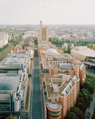 walking through Potsdamer Platz in Berlin and its postmodernist architecture, showing large scale buildings with transparencies and grids