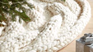 An ivory white chunky knitted tree skirt