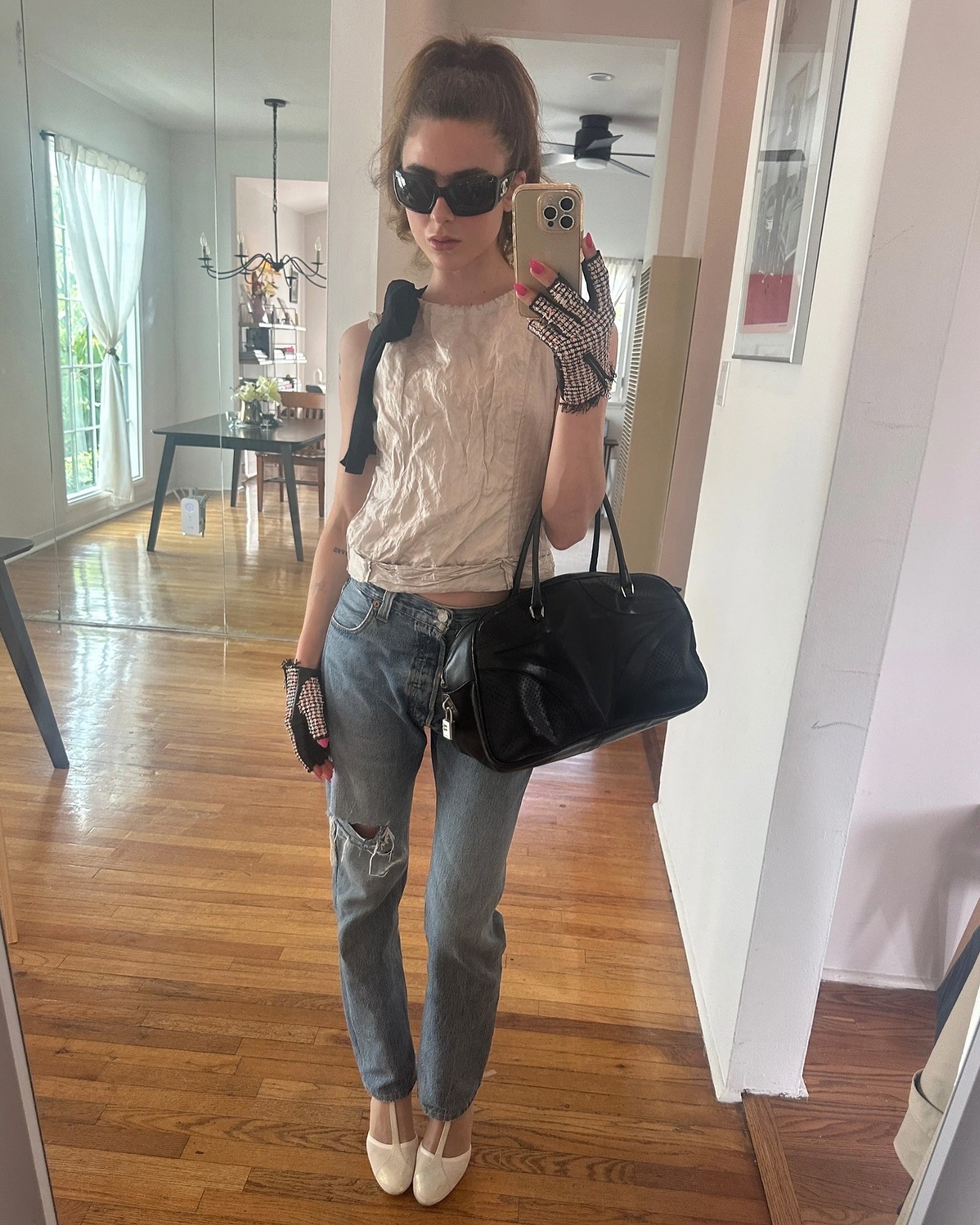An image of @cierraoday wearing jeans and heels.