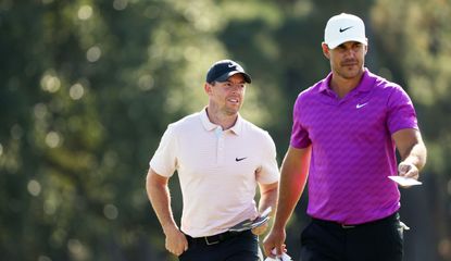 Rory McIlroy and Brooks Koepka walk down the fairway during The 2020 Masters