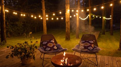 Fire pit on patio with festoon lights