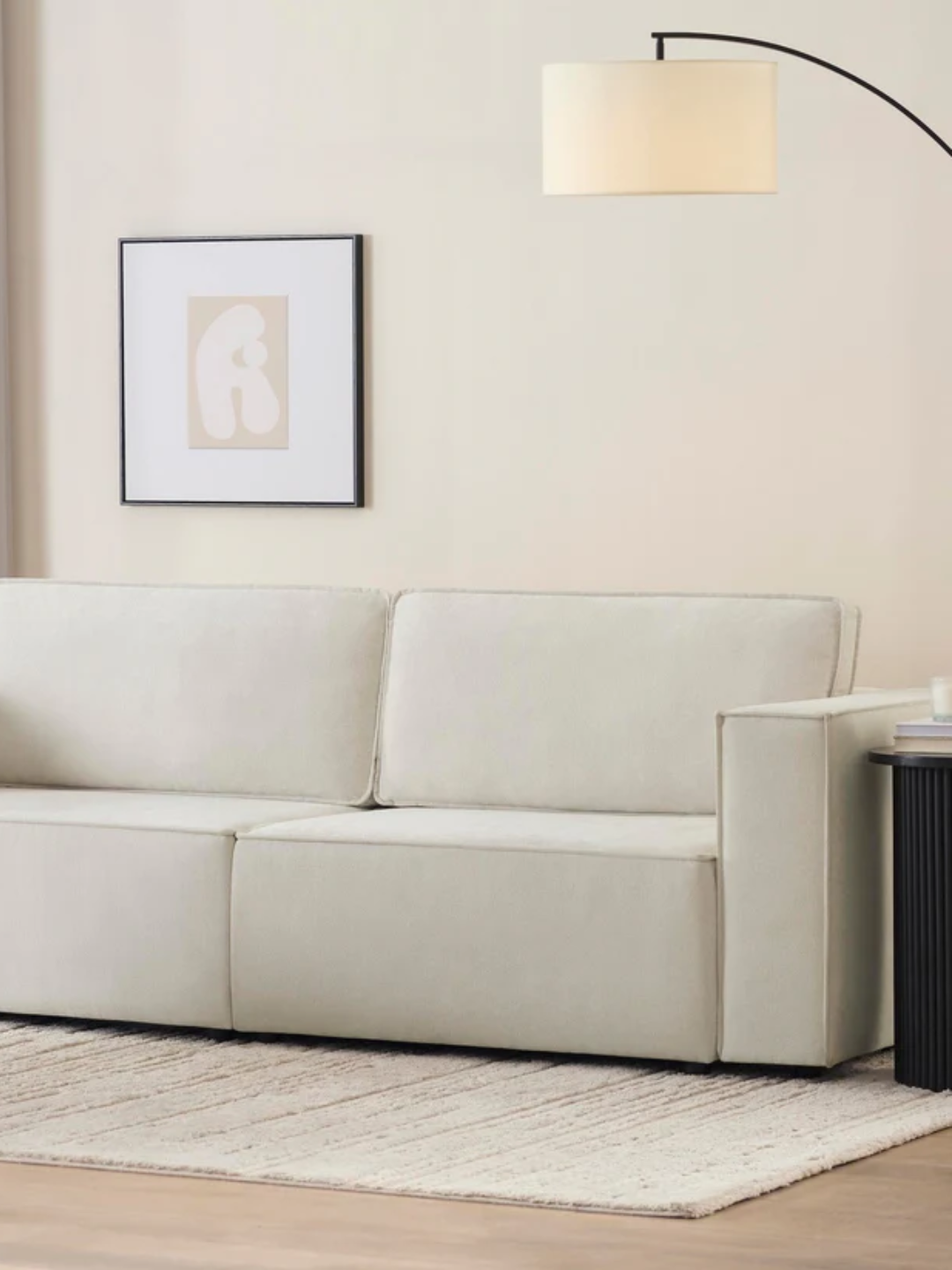 An ivory sofa bed from DUSK in a minimalist living room