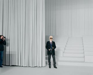 Man stood in white room at the foot of some stairs
