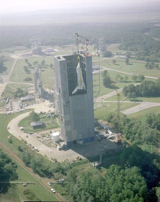 An aerial view of NASA's orbiter Enterprise being hoisted into the Marshall Space Flight Center's Dynamic Test Stand for the Mated Vertical Ground Vibration test on Oct. 4, 1978.