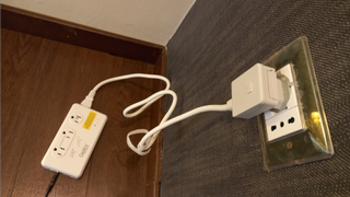 Ceptics 220V to 110V Travel Voltage Converter plugged into wall in hotel