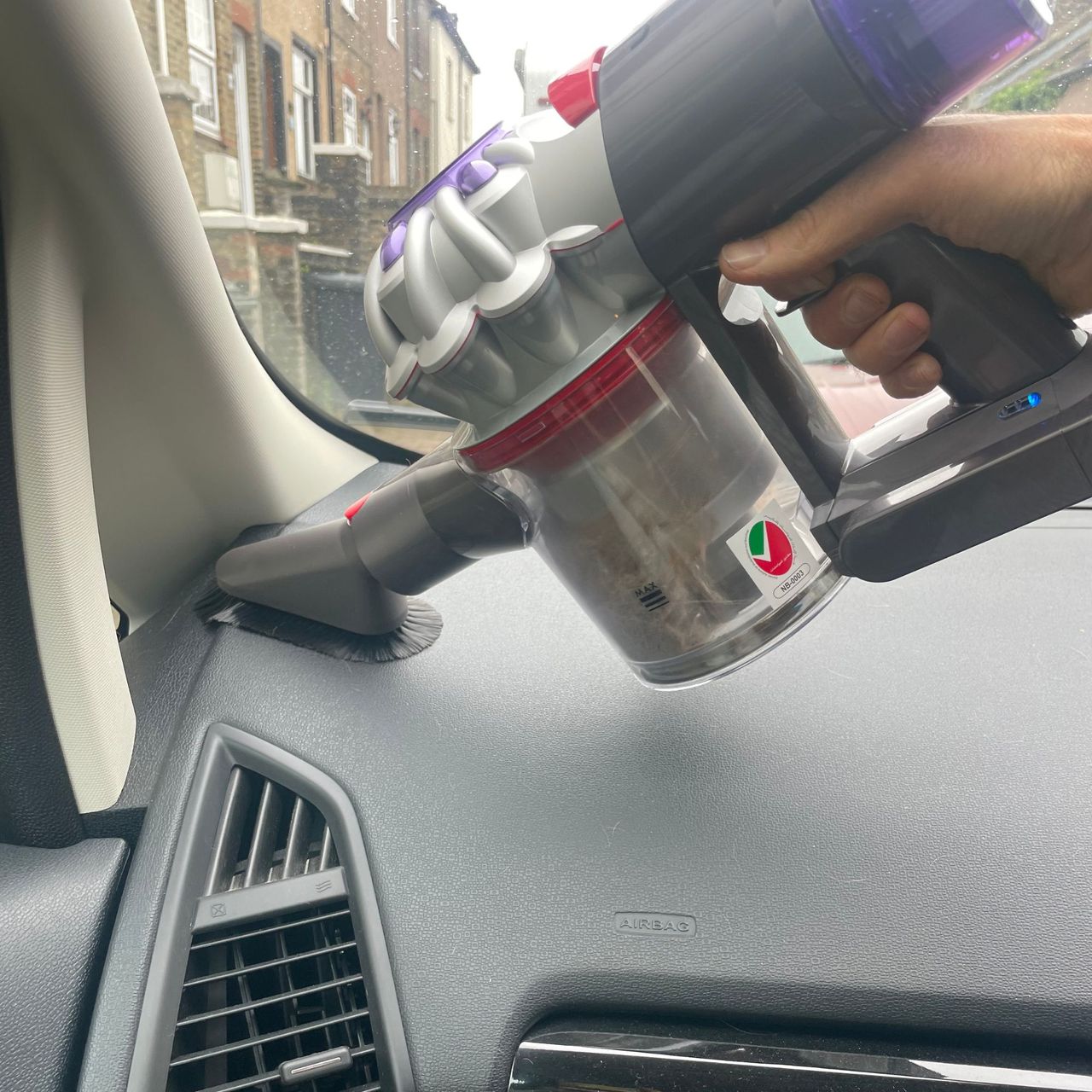 Using the Dyson soft cleaning tool in a car