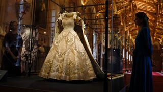 The Coronation Dress and Robe of Estate, worn by Britain's Queen Elizabeth II on her 1953 coronation, and designed by Norman Hartnell and Ede & Ravenscroft respectively, are pictured during a press preview for the Platinum Jubilee - The Queen's Coronation exhibition, in St George's Hall at Windsor Castle in Windsor on July, 6, 2022. As part of the celebration of The Queen's historic Platinum Jubilee in 2022, Windsor Castle will host a special display commemorating The Queen's Coronation at Westminster Abbey on 2 June 1953. (Photo by CARLOS JASSO / AFP) / -- IMAGE RESTRICTED TO EDITORIAL USE - STRICTLY NO COMMERCIAL USE -- ONLY TO BE USED IN CONNECTON WITH THE PLATINUM JUBILEE: THE QUEEN'S CORONATION AT WINDSOR CASTLE