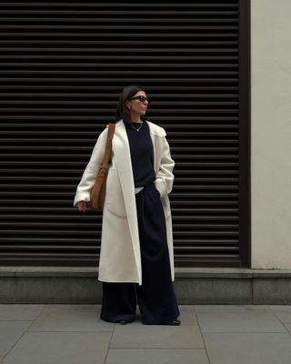 Francesca Safarri wears a white wool coat